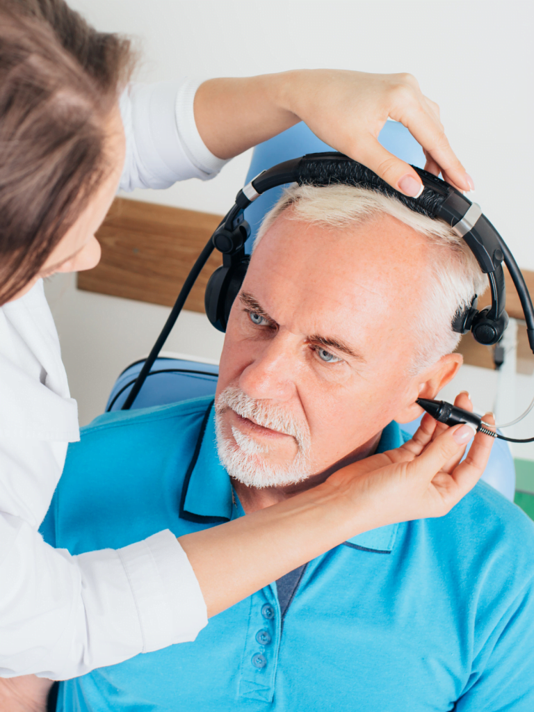 A man receiving an audiology or hearing test