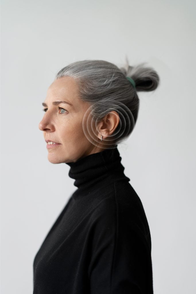 A photo of a woman with a graphic of listening to sounds